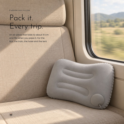 Grey air pillow against a train window seat