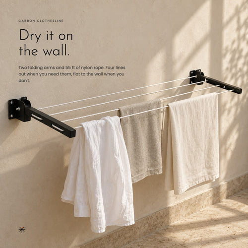 Linen laundry drying on the clothesline against a sunlit plaster wall
